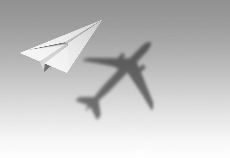 Paper Airplane Flying With Shadow Of A Real Airplane Isolated On - The ...